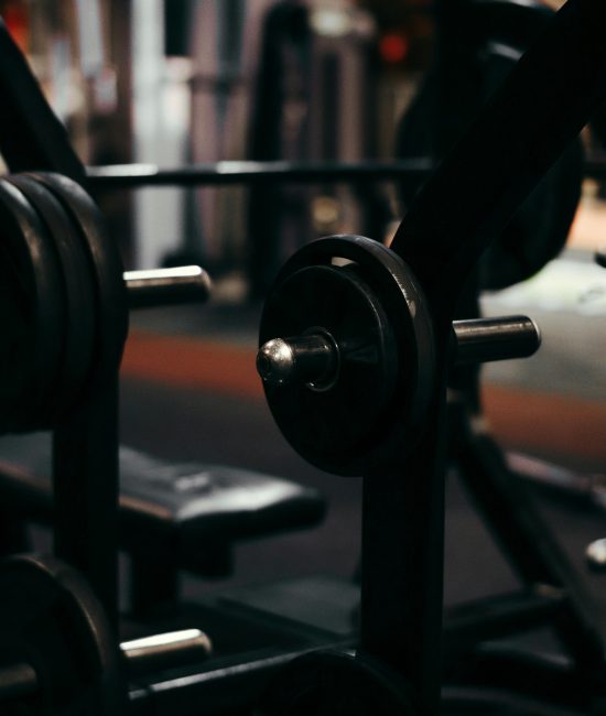 An up-close view of weightlifting equipment in a modern gym setting, perfect for fitness enthusiasts.
